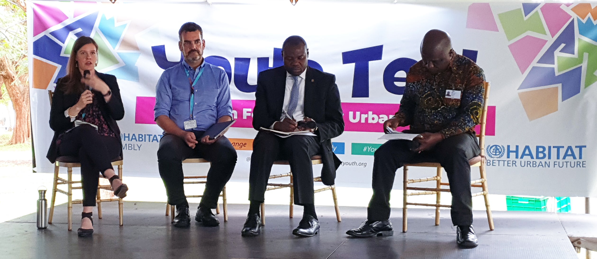 Four people sitting on a panel discussion.