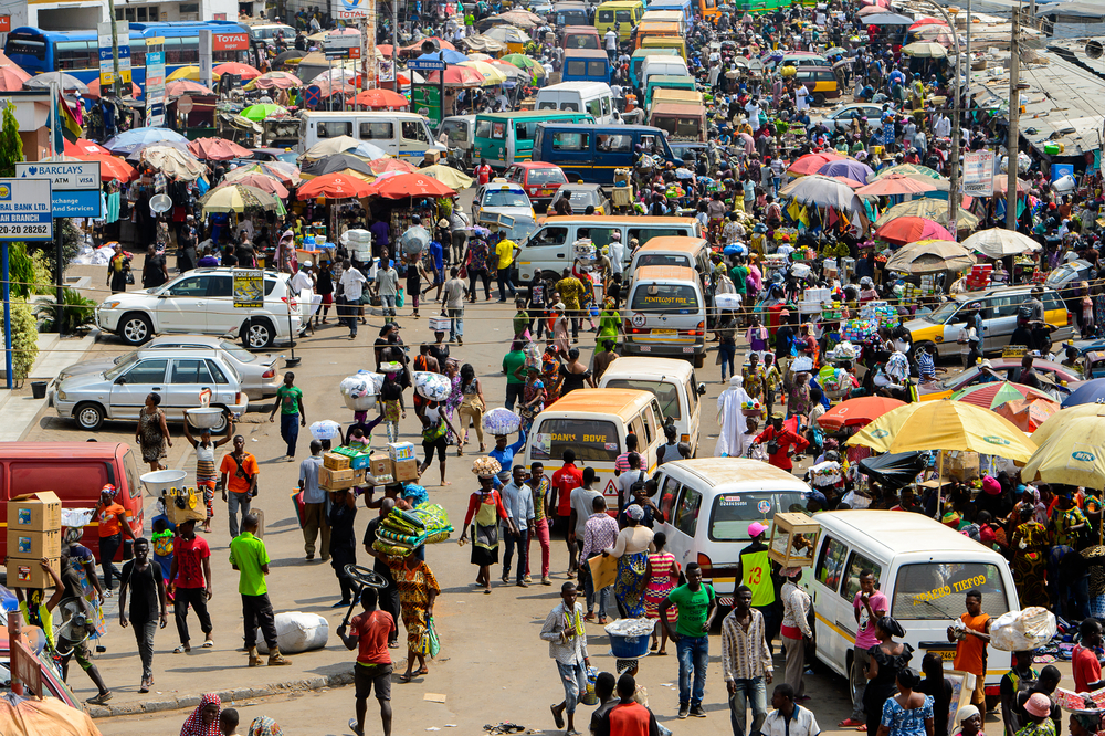 People buy and sell goods at the Kumasi market in Ghana