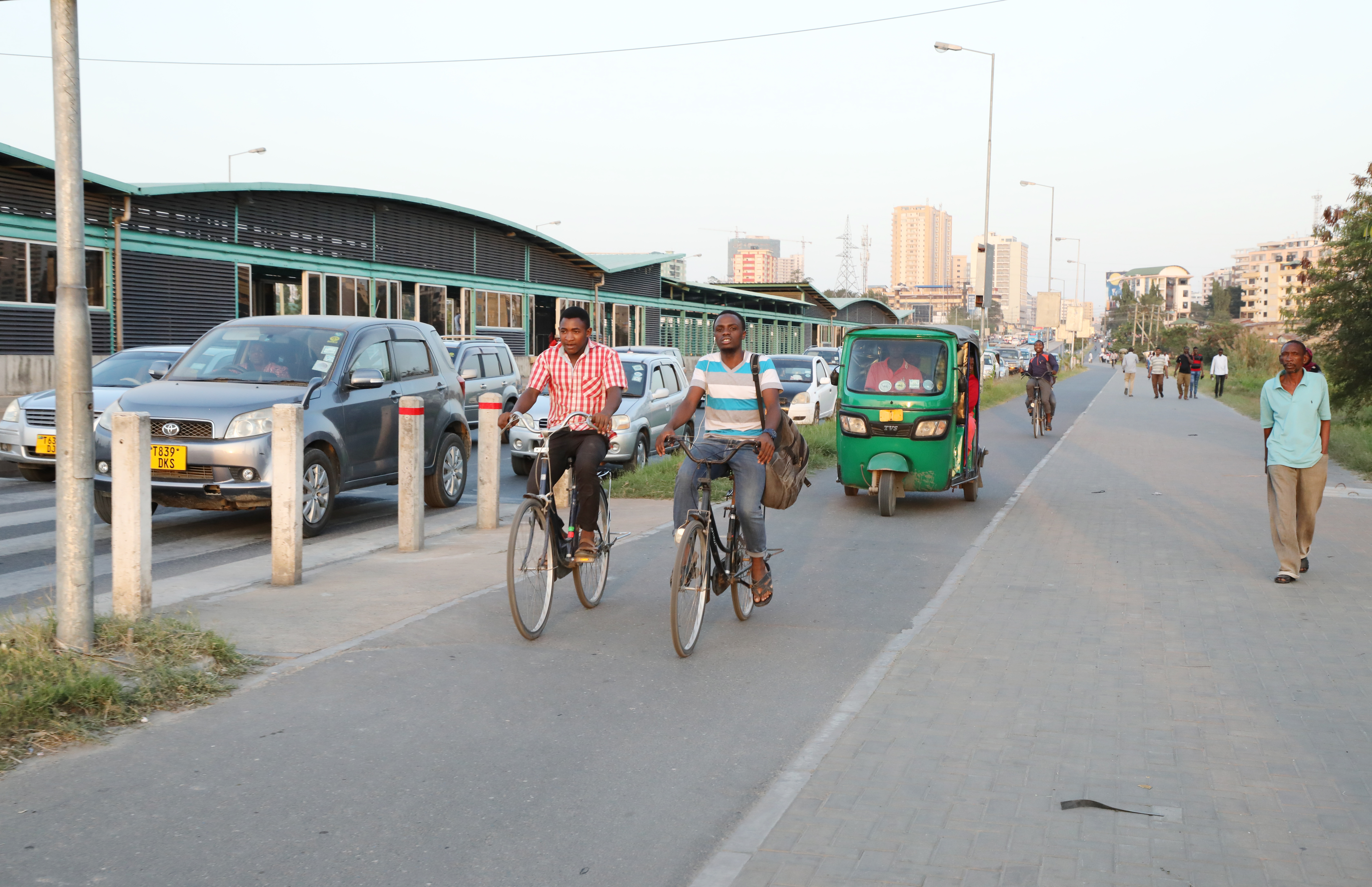 Street overview of the Jangwani terminal with a pedestrian walk way as well as a cycling lane, an example of an all-inclusive mobility street in Dar es Salaam, Tanzania.