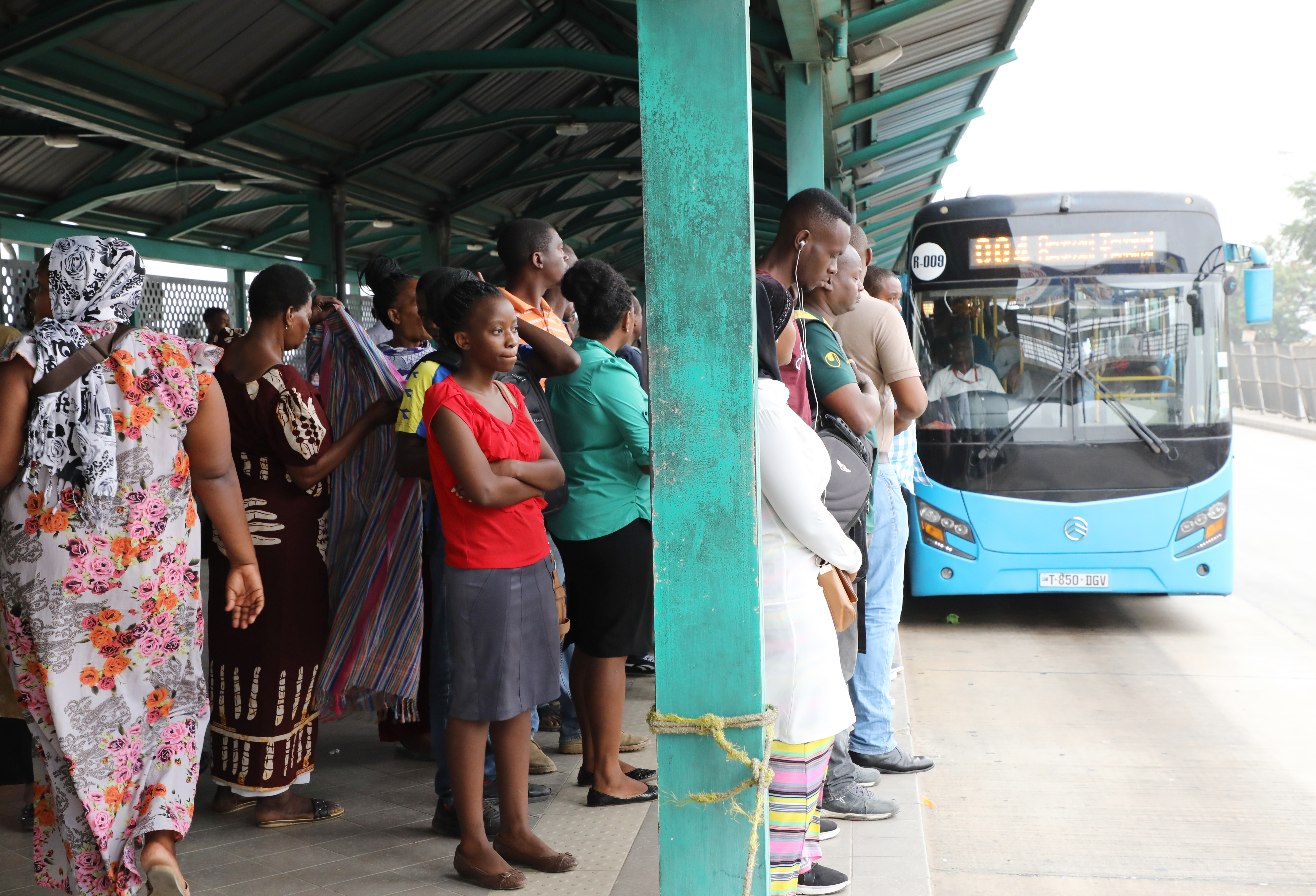 Passengers wait to board a BRT bus at Kimara terminal in Dar es Salaam, Tanzania