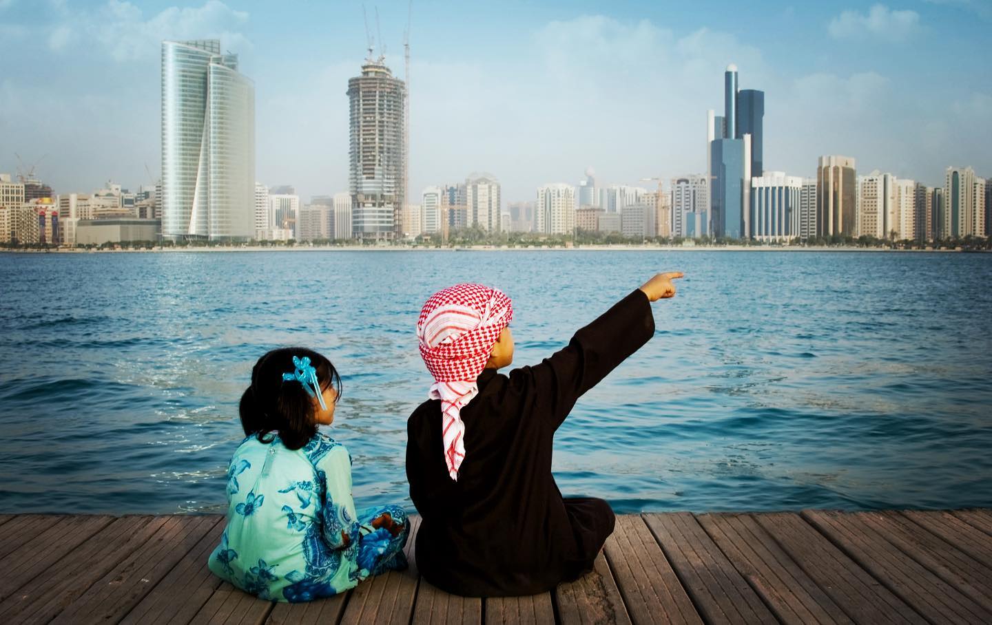 Two children look at a view of Abu Dhabi