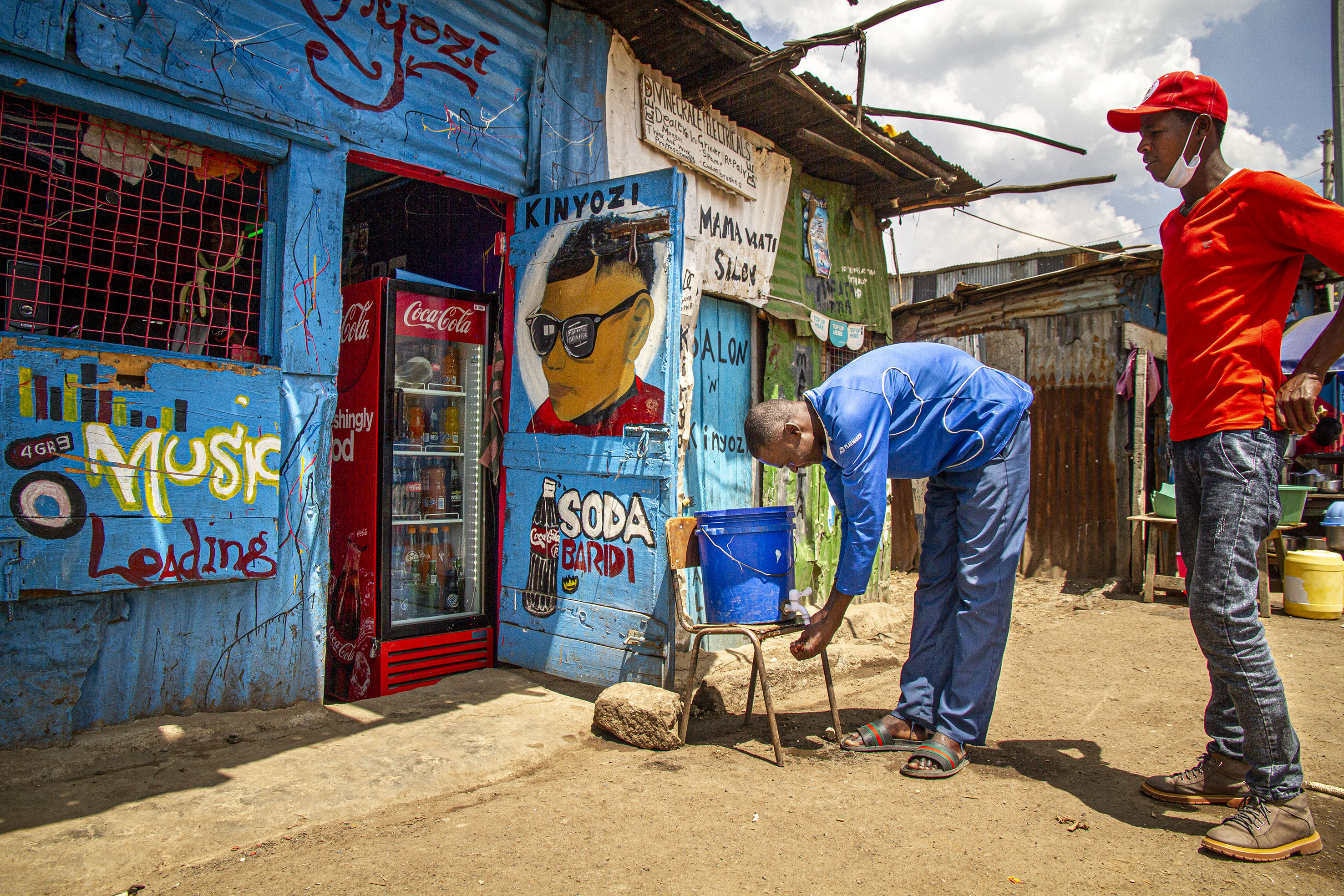 Youth at a handwashing station in Mathare slum, Nairobi, Kenya
