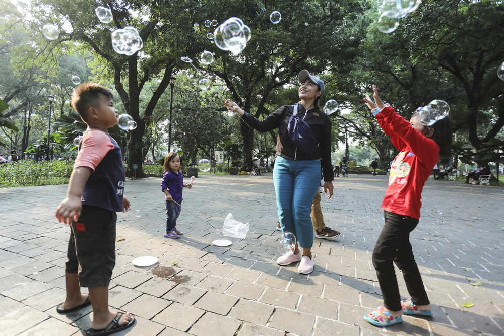 Children play with their parents at Suropati Park, Jakarta Indonesia