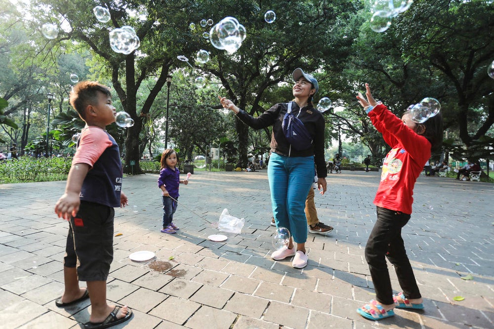 Children play with their parents at Suropati Park, Jakarta Indonesia