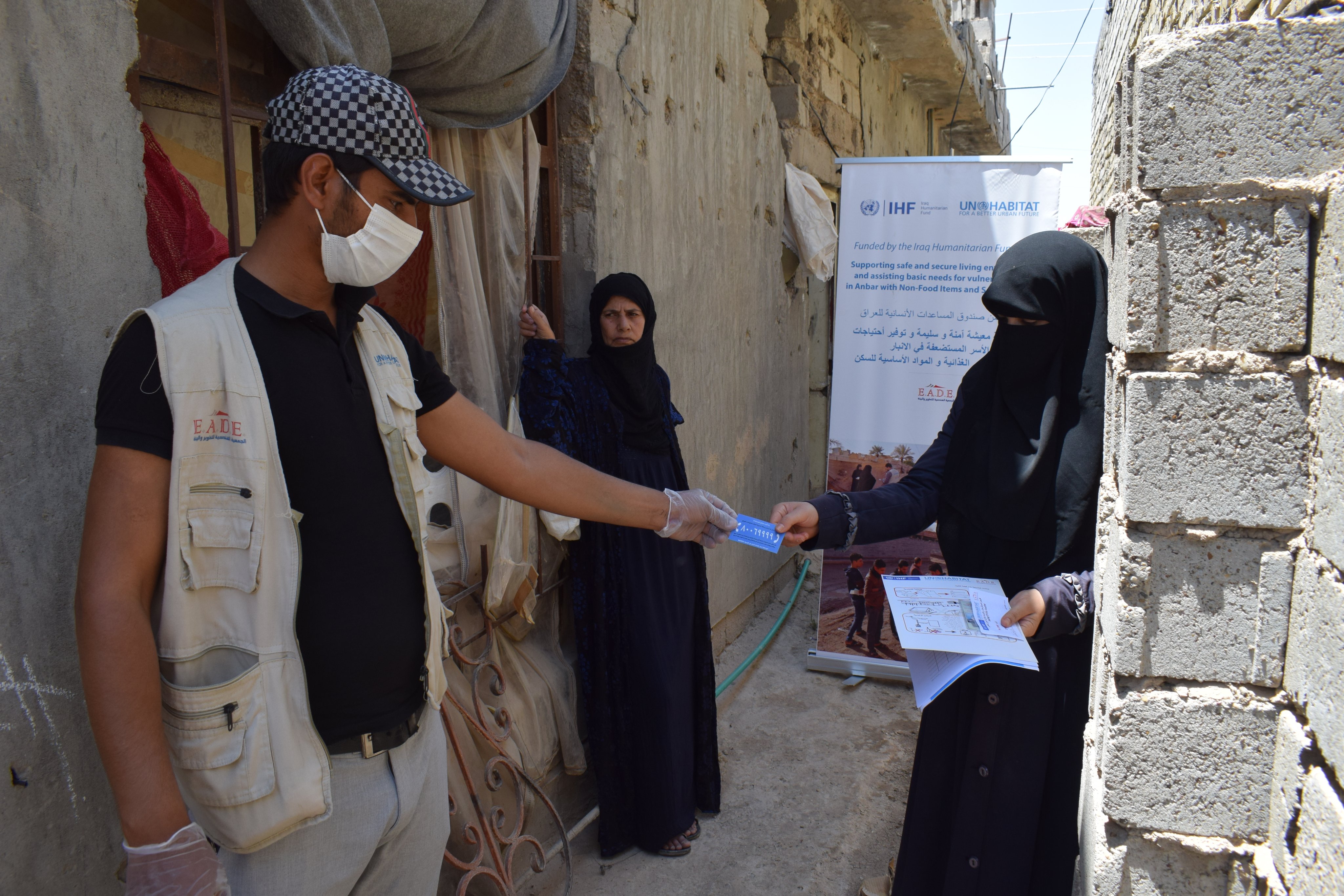 A UN-Habitat staff member does community sensitization on the shelter upgrading project in Anbar, Iraq
