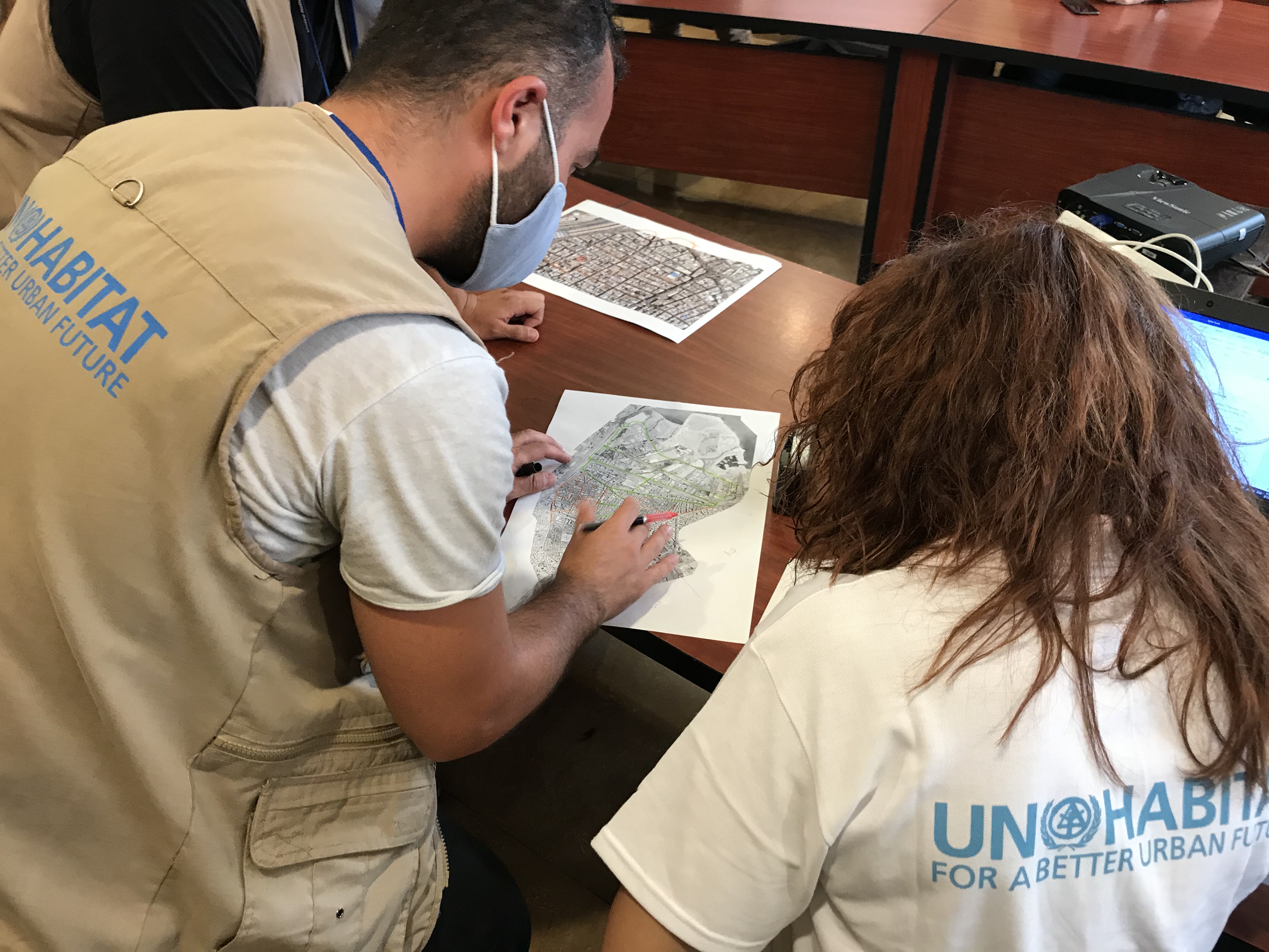 UN-Habitat team examines maps of blast-affected areas as part of the rapid building-level damage assessment in Beirut.