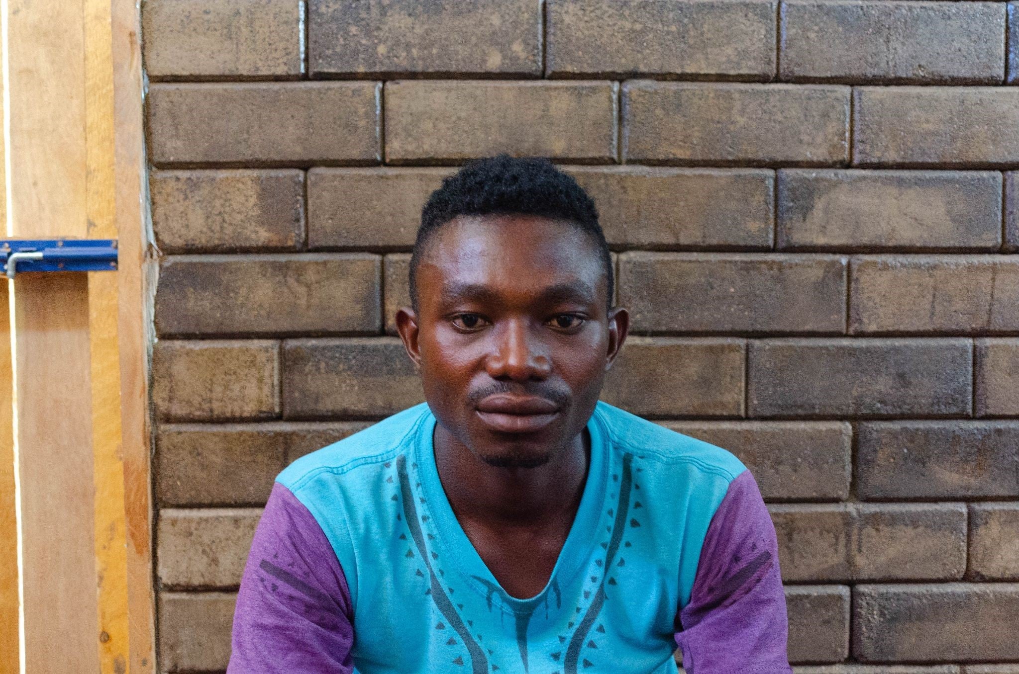 Nimbona Isaac outside one of the shelters he helped build as part of the collaboration with Shigeru Ban. Source: UN-Habitat