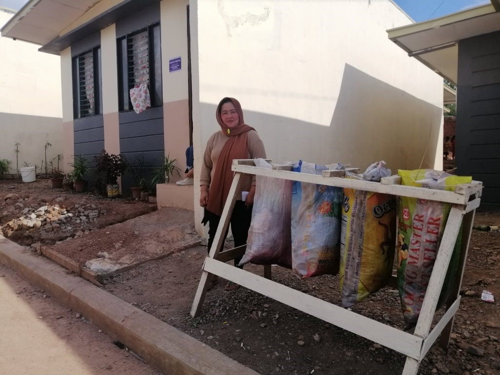 Hanifah with improvised waste segregation bins in their community