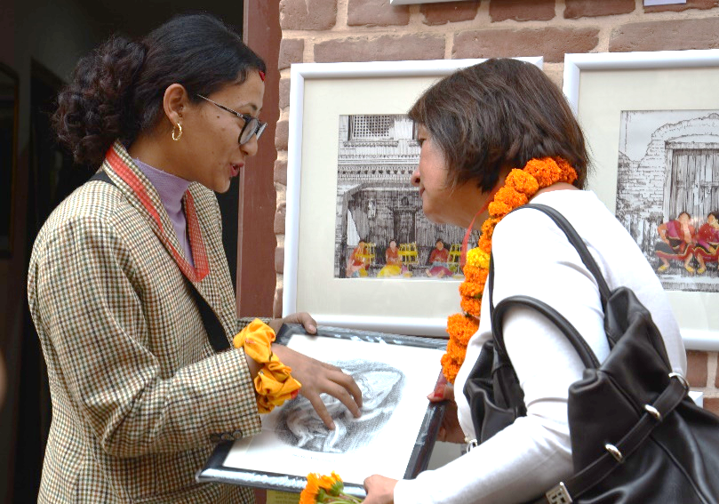 Priyanka Maharjan, project beneficiary and a young artist, explaining her arts to the EU Ambassador @UNHabitat/Sagar BC  