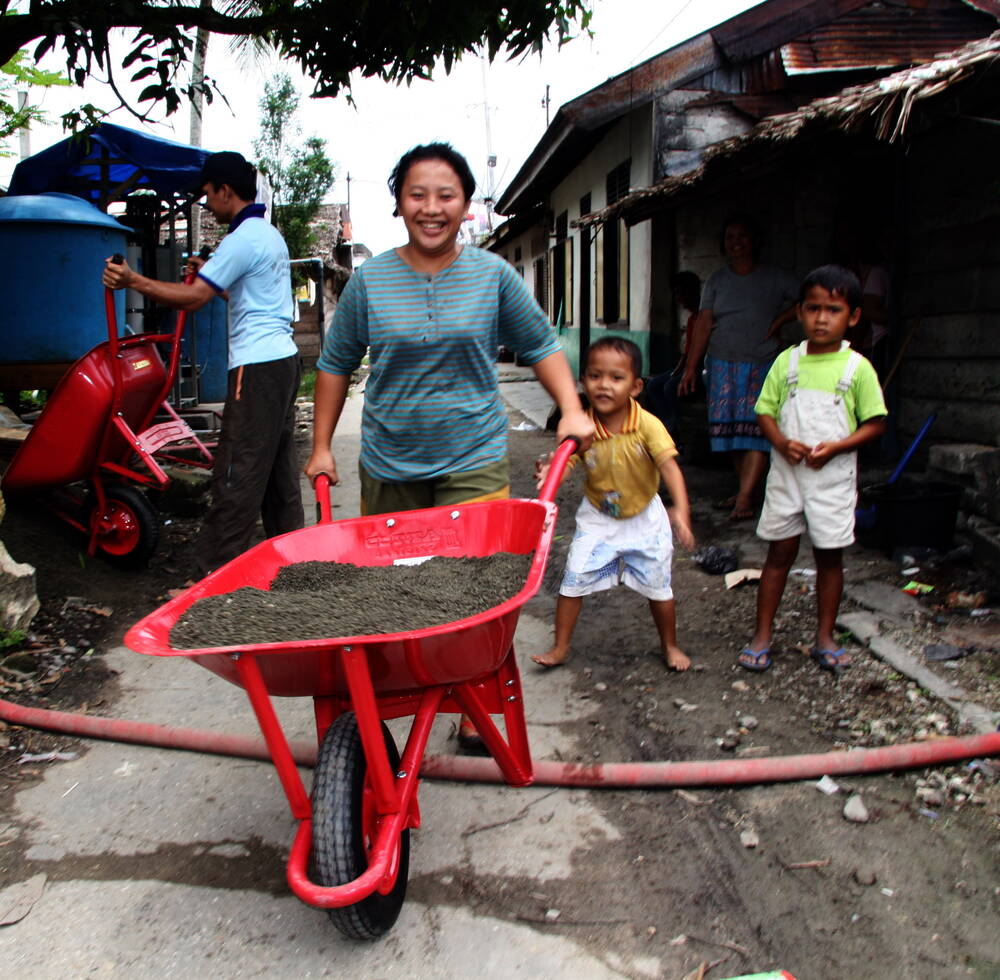 Woman pushing a wheelbarrow