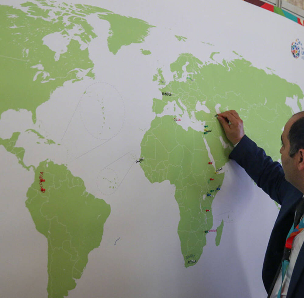 Pins are placed on a world map to indicate where pledges have been made towards UN-Habitat's work.