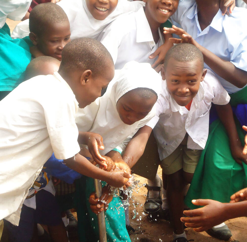 Students of Milimani A,B,C,and D access clean water from a tap