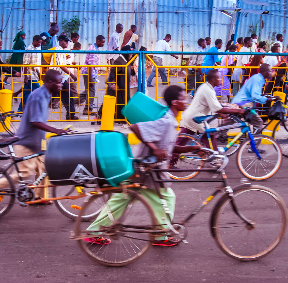 Flow of people walking and with bicycles in Mombasa