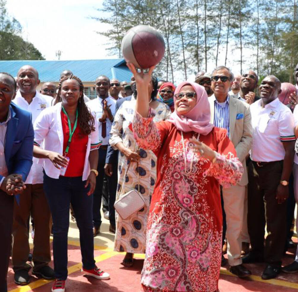 Head of UN-Habitat shoots some basketball outside the centre