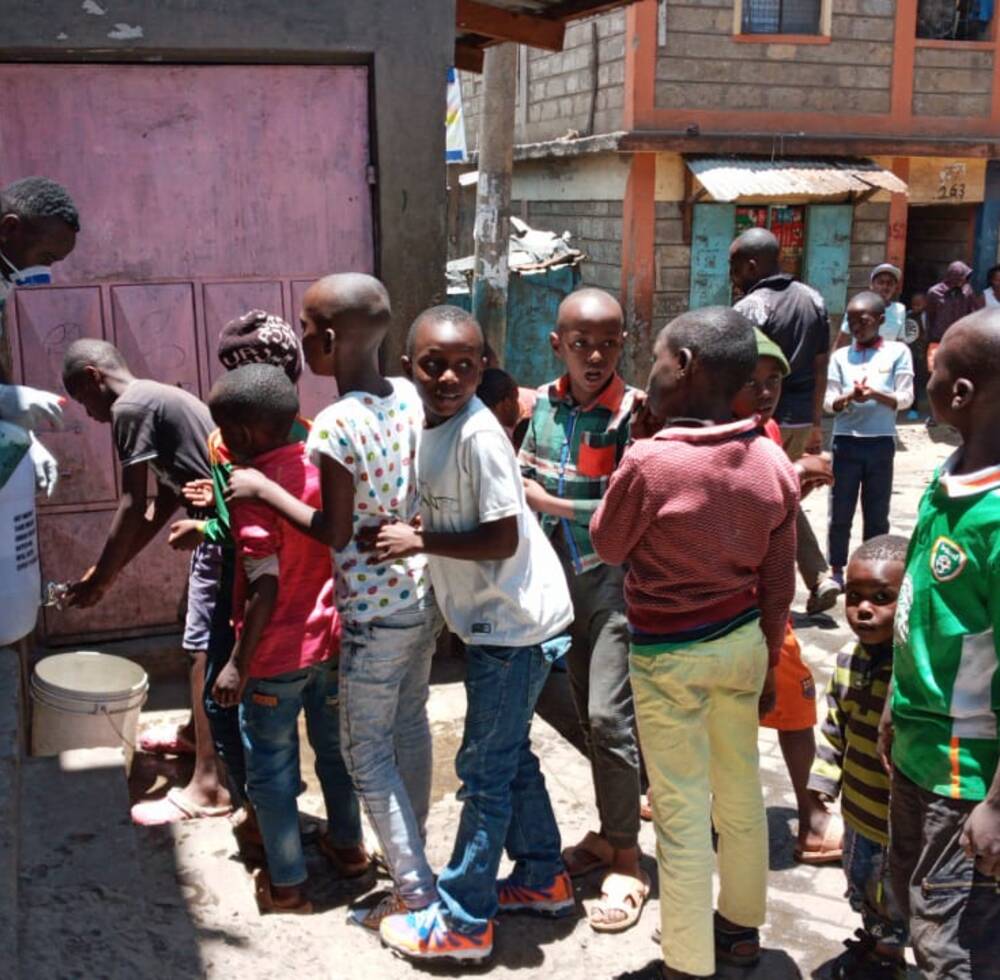 Kenyan youth wash hands to keep away  Covid-19 in informal settlement