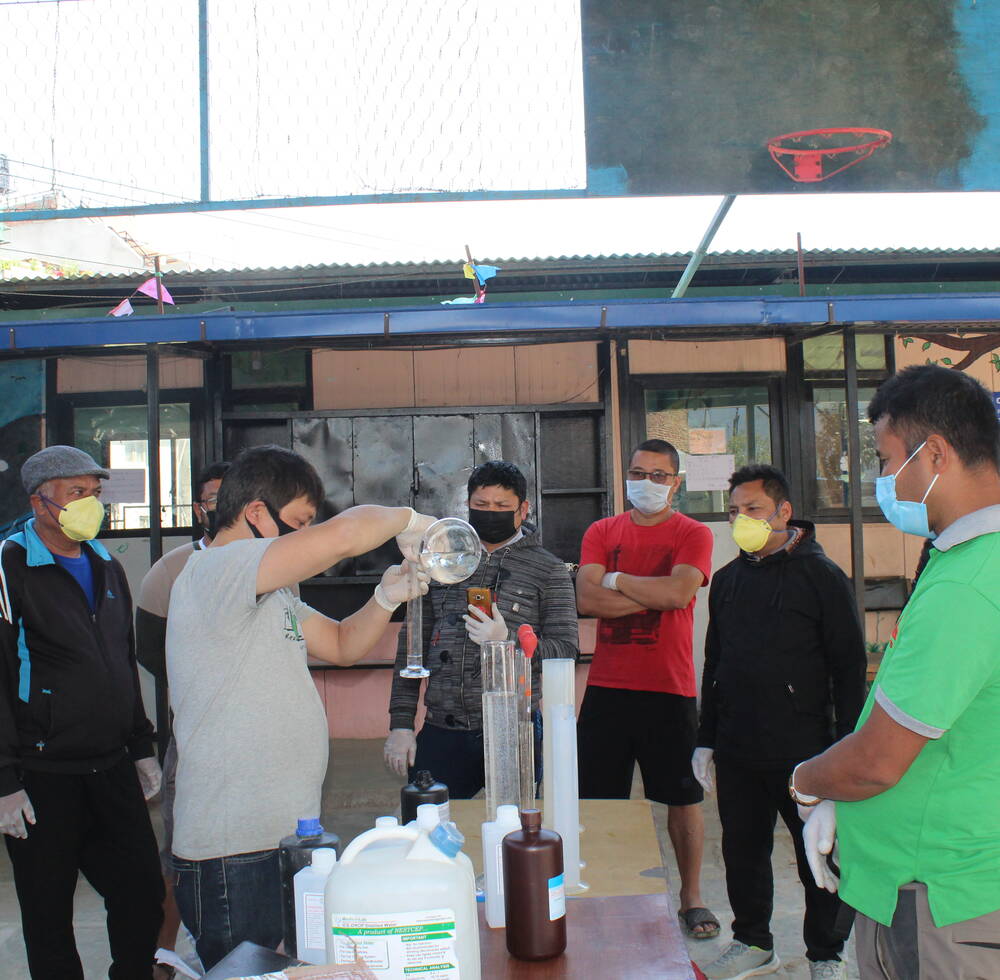 Home-based handicraft workers in Nepal retrained in making material to protect against COVID-19 hand over masks to the municipality representative April 2019