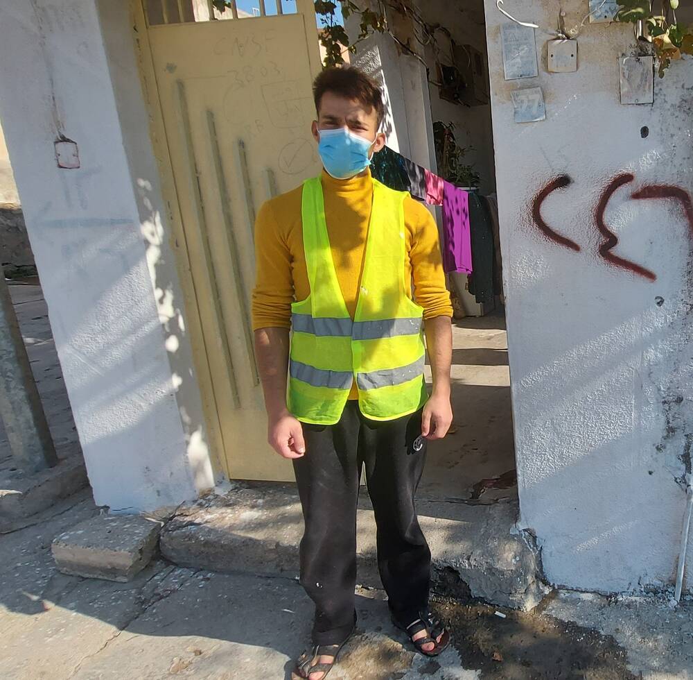 Saud Hussein, a young IDP standing in front of his rehabilitated house in Duhok, Iraq where he proudly worked as a painter through a project implemented by UN-Habitat (3 December 2020)