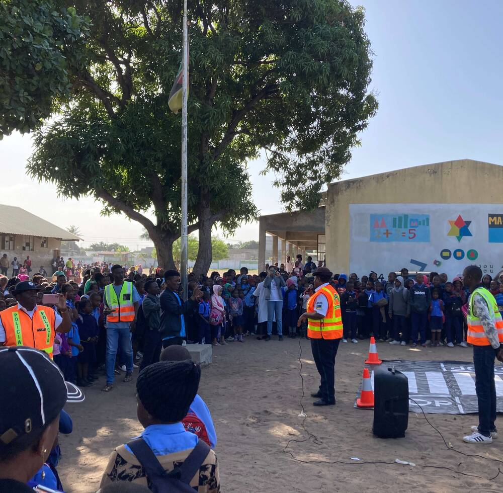 UN-Habitat team, Traffic Police officers and AMVIRO members instructing students from 8 March Primary School on road safety and the proper use of the newly opened pedestrian crossing.