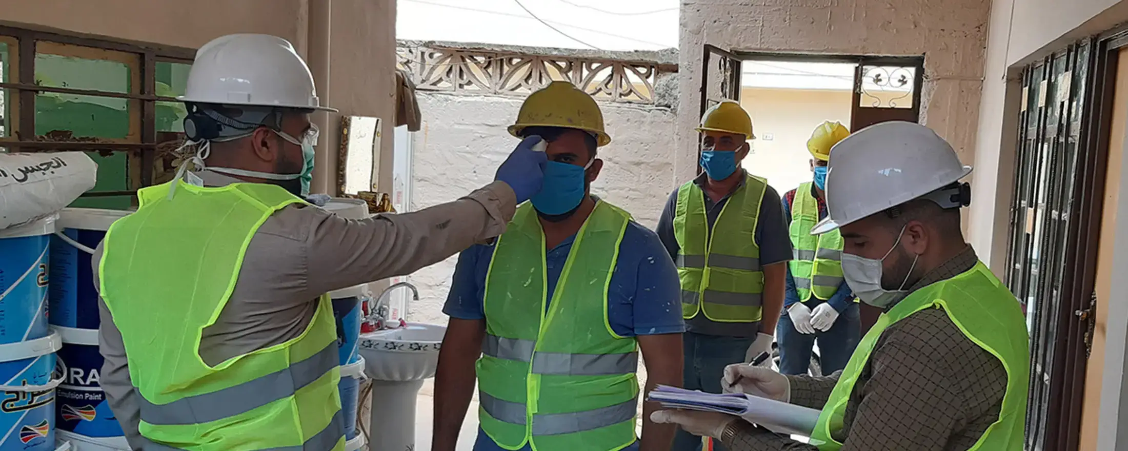 UN-Habitat workers undergoing through temperature check on entering construction site in Mosul