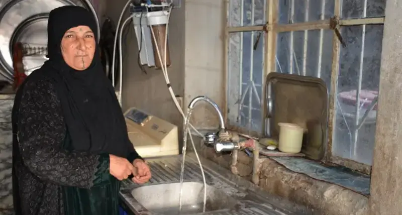 Um Ali, who lost her husband after an ISIL-related attack, receives rehabilitated housing from a UN-Habitat in Iraq, supported by Alwaleed Philanthropies