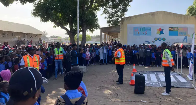 UN-Habitat team, Traffic Police officers and AMVIRO members instructing students from 8 March Primary School on road safety and the proper use of the newly opened pedestrian crossing.
